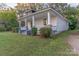 Attractive home with covered porch, brick accents, and lush greenery in a serene setting at 319 Chestnut St, Rock Hill, SC 29730