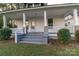 Charming front porch with inviting steps, white railings, and attractive brick pillar accents at 319 Chestnut St, Rock Hill, SC 29730
