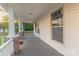 Inviting front porch featuring white columns, wood floors, and a large window at 319 Chestnut St, Rock Hill, SC 29730