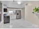 Bright updated kitchen with white cabinets, marble floors, and stainless steel appliances at 319 Chestnut St, Rock Hill, SC 29730