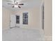 Bright living room featuring white marble floors, cream walls, and a modern ceiling fan at 319 Chestnut St, Rock Hill, SC 29730