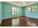 Bedroom featuring ceiling fan, two windows and wood look floors at 322 Electra Ln, Stanley, NC 28164