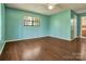 Bright bedroom featuring ceiling fan, window and wood look floors at 322 Electra Ln, Stanley, NC 28164