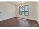 Bright dining room featuring a large window, chandelier and hardwood floors at 322 Electra Ln, Stanley, NC 28164