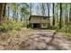 Exterior view of house with garage, showing its design and location in a wooded setting at 322 Electra Ln, Stanley, NC 28164