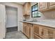 Well-lit kitchen with solid surface countertops, wood cabinets and modern appliances at 322 Electra Ln, Stanley, NC 28164
