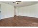 Inviting living room featuring hardwood floors, neutral walls, and access to other rooms at 322 Electra Ln, Stanley, NC 28164