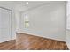 Bedroom with hardwood floors, closet, and large windows for natural light at 322 Flat Rock Dr, Denver, NC 28037