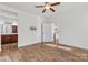 Bedroom with hardwood floors, neutral walls, and doorways to bathroom and other rooms at 322 Flat Rock Dr, Denver, NC 28037