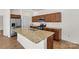 Kitchen island features a granite countertop, stainless steel appliances, and dark wood cabinets at 322 Flat Rock Dr, Denver, NC 28037