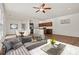 Open-concept living room and kitchen with modern appliances, hardwood floors, and stylish decor at 322 Flat Rock Dr, Denver, NC 28037