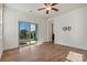 Bright living room with hardwood floors, ceiling fan, and sliding glass doors leading to a patio at 322 Flat Rock Dr, Denver, NC 28037