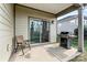 Covered patio featuring an outdoor grill, seating and sliding doors to the interior at 322 Flat Rock Dr, Denver, NC 28037