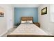 Comfortable bedroom featuring a wooden bed frame, stylish bedding, and calming blue accent wall at 3224 Selwyn Farms Ln # 3, Charlotte, NC 28209