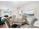 Open-concept dining with gray tufted chairs, visible fireplace, and view of the kitchen at 3224 Selwyn Farms Ln # 3, Charlotte, NC 28209