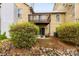 Back exterior view with small patio, chairs, and a second-story deck at 3224 Selwyn Farms Ln # 3, Charlotte, NC 28209