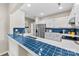 Bright kitchen with white cabinets, blue tile backsplash, and stainless steel appliances at 3224 Selwyn Farms Ln # 3, Charlotte, NC 28209