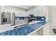 Bright kitchen featuring a breakfast bar with stylish blue tile, stainless steel appliances, and white cabinets at 3224 Selwyn Farms Ln # 3, Charlotte, NC 28209