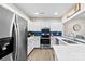 Modern kitchen with stainless steel appliances, white cabinetry, and blue tile backsplash, offering ample counter space at 3224 Selwyn Farms Ln # 3, Charlotte, NC 28209