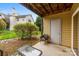 Outdoor patio with table and chair, covered by upper level with utility door at 3224 Selwyn Farms Ln # 3, Charlotte, NC 28209