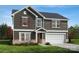 Charming two-story home featuring gray siding, white trim, a two-car garage, and well-maintained landscaping at 3252 Maya Ln # 46, Midland, NC 28107