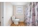 Bathroom with toilet, window, and floral shower curtain at 382 Cole Campbell Rd, Taylorsville, NC 28681