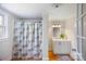 Bathroom featuring a single sink vanity, floral shower curtain, and wood flooring at 382 Cole Campbell Rd, Taylorsville, NC 28681