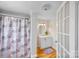 Bathroom featuring a single sink vanity, floral shower curtain, and wood flooring at 382 Cole Campbell Rd, Taylorsville, NC 28681
