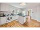 Bright kitchen featuring white cabinets, an island, and hardwood floors at 382 Cole Campbell Rd, Taylorsville, NC 28681