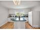 Bright kitchen featuring white cabinets, an island, and modern appliances at 382 Cole Campbell Rd, Taylorsville, NC 28681