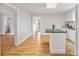 Bright kitchen featuring white cabinets, an island, and hardwood floors at 382 Cole Campbell Rd, Taylorsville, NC 28681