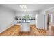 Bright kitchen featuring white cabinets, an island, hardwood floors and natural light at 382 Cole Campbell Rd, Taylorsville, NC 28681