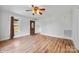 Bright living room with hardwood floors, a ceiling fan, and an updated front door at 382 Cole Campbell Rd, Taylorsville, NC 28681