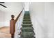 Carpeted staircase with wooden railing and white spindles at 382 Cole Campbell Rd, Taylorsville, NC 28681