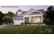 Charming two-story home with a manicured lawn, inviting porch, and integrated two-car garage at 39 Five Creek Rd # 39, Charlotte, NC 28213