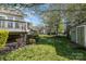 Spacious backyard featuring lush green grass, storage shed, and partial view of back porch at 408 Harvest Ter, Clover, SC 29710