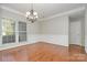 Spacious dining room with hardwood floors, wainscoting, and chandelier lighting at 408 Harvest Ter, Clover, SC 29710