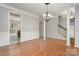 Open dining area boasts hardwood floors, columns, wainscoting, and chandelier at 408 Harvest Ter, Clover, SC 29710