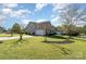 Well-maintained home featuring a spacious lawn, mature trees, and an attached two-car garage at 408 Harvest Ter, Clover, SC 29710