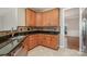 Galley kitchen boasts rich wood cabinetry, granite countertops and tile backsplash at 408 Harvest Ter, Clover, SC 29710