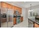 Well-equipped kitchen features stainless steel appliances and warm wood cabinets at 408 Harvest Ter, Clover, SC 29710