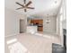 Open-concept living room with fireplace seamlessly flowing into the kitchen with stainless appliances at 408 Harvest Ter, Clover, SC 29710