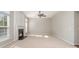 Bright living room featuring a cozy fireplace, neutral carpet, and ample natural light at 408 Harvest Ter, Clover, SC 29710