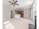 Open-concept living room with fireplace seamlessly flowing into the kitchen with stainless appliances at 408 Harvest Ter, Clover, SC 29710