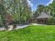 Beautiful backyard featuring a pool, outdoor kitchen, and covered entertaining area at 4400 Sharon View Rd, Charlotte, NC 28226