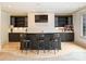 Finished basement bar with seating, modern fixtures, and a flat screen television offers the perfect entertaining spot at 4400 Sharon View Rd, Charlotte, NC 28226