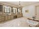Luxurious bathroom featuring a chandelier, a soaking tub, and a vanity with granite countertops at 4400 Sharon View Rd, Charlotte, NC 28226