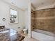 Charming bathroom featuring a tub with tiled surround and a vanity with marble countertop at 4400 Sharon View Rd, Charlotte, NC 28226