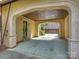 An elegant carport with stone archway and brick floors providing covered parking at 4400 Sharon View Rd, Charlotte, NC 28226