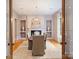 Formal dining room with fireplace, hardwood floors, and stylish chandelier at 4400 Sharon View Rd, Charlotte, NC 28226